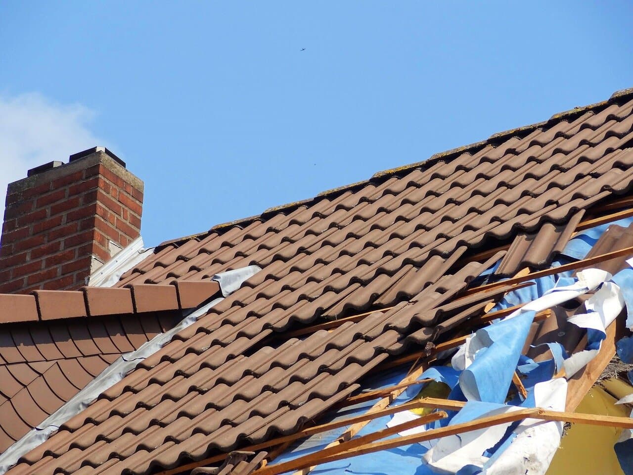 Severe storm damage to residential roof in Greater Philadelphia area showing structural damage from high winds and hail