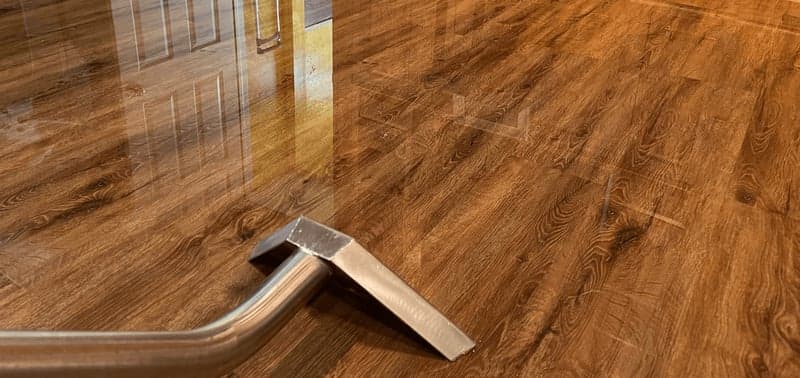 Bulldog Restoration technician performing water extraction from hardwood floors after burst pipe flooding in Philadelphia